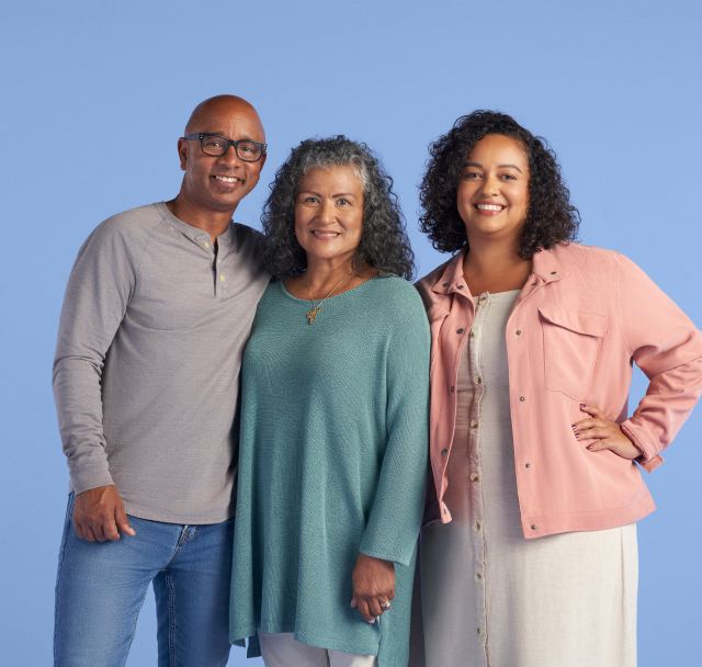 family smiling together with blue background 